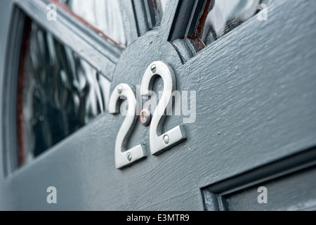 Chrome number 2's mounted on a front door to create the number twenty two to identify the homes address Stock Photo