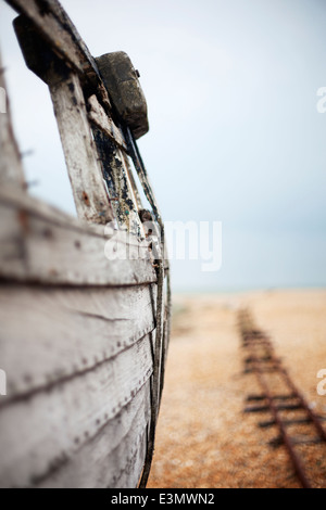 wooden fishing boat left to rot and decay on the shingle beach at ...