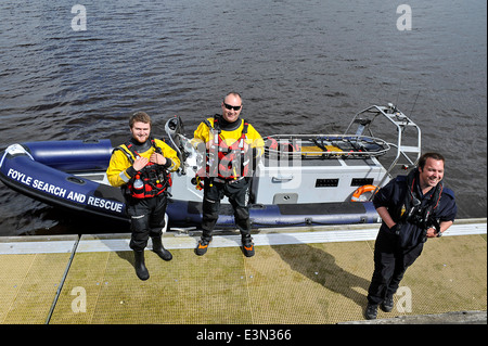 Crew members of the emergency Foyle Search And Rescue, wearing life jackets, on duty at the River Foyle, Derry, Londonderry Stock Photo