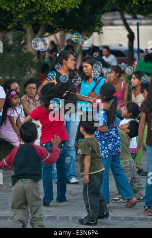 Kids blow bubbles during the DIA DE LOS LOCOS (DAY OF THE CRAZIES) - SAN MIGUEL DE ALLENDE, GUANAJUATO, MEXICO Stock Photo