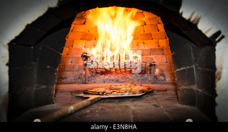 A Pizza in the wooden oven Stock Photo