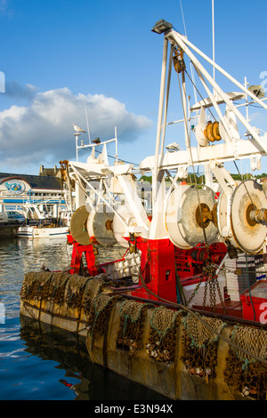 Two matching commercial fishing boats with nets docked in Port-en-Bessin, Normandy, France Stock Photo