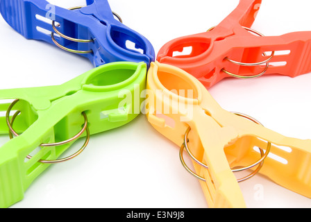 colorful clothespins line up on white Stock Photo