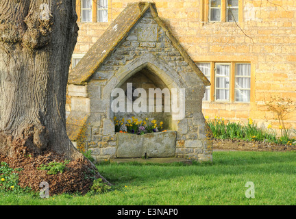 Old Water trough at Lower Slaughter, part of the Slaughters with Upper Slaughter, in The Cotswolds, Gloucestershire, England, UK Stock Photo