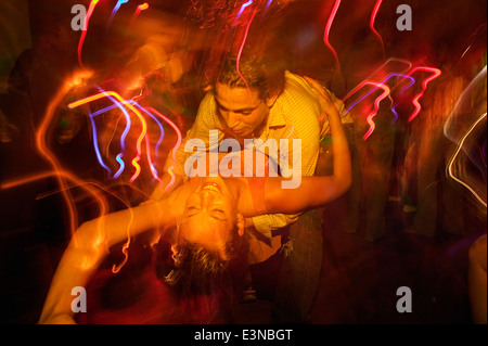 Couple dancing together in nightclub Stock Photo