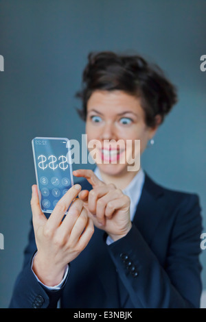 Surprised Businesswoman Using Futuristic Transparent Mobile With Dollar Sign Stock Photo