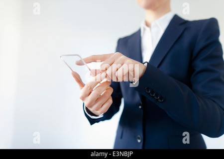 Close-up Of Businesswoman Using Transparent Smartphone Stock Photo