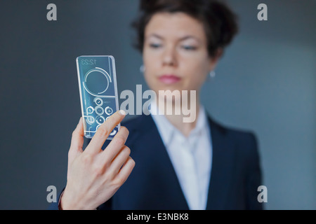 Portrait Of Businesswoman Using Modern Transparent Smartphone Stock Photo