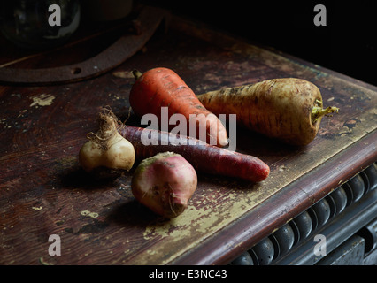 Root vegetables on wooden table Stock Photo