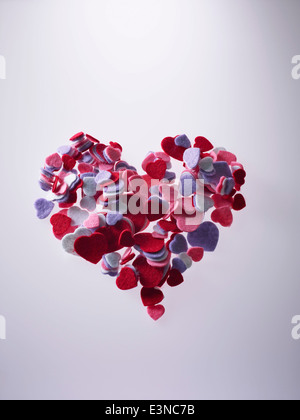 Velvet heart shapes over gray background Stock Photo