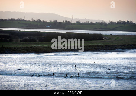 Surfers and canoeists riding the Severn Bore tidal wave at Newnham-on-Severn, Gloucestershire UK 2014 Stock Photo