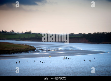 Surfers and canoeists waiting for the approaching Severn Bore tidal wave at Newnham-on-Severn, Gloucestershire UK 2014 Stock Photo