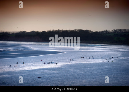 Surfers and canoeists waiting for the approaching Severn Bore tidal wave at Newnham-on-Severn, Gloucestershire UK 2014 Stock Photo