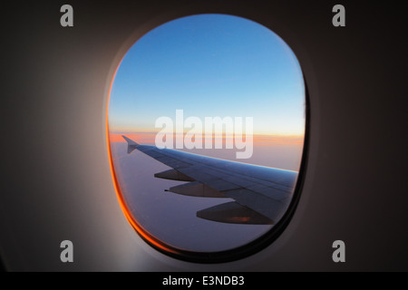 A window view of the wing of a modern luxury jet plane Stock Photo