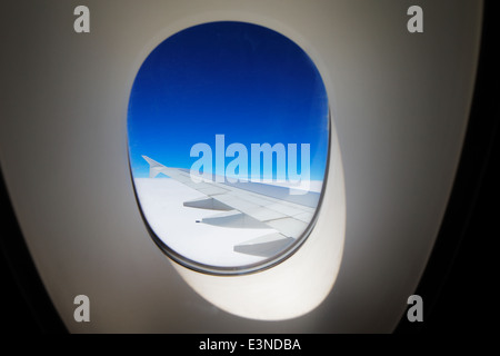 A window view of the wing of a modern luxury jet plane Stock Photo