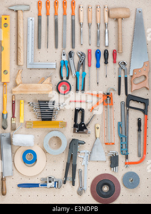Various carpentry, construction tools hanging on the board. Stock Photo