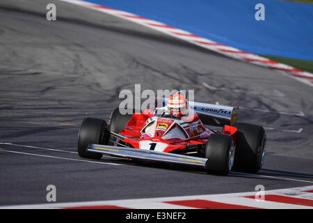 Spielberg, Austria. 21st June, 2014. The non-executive chairman of Mercedes AMG, former Austrian Formula One driver Niki Lauda, steers his 1976 Ferrari 312T2 at the Red Bull Ring race track in Spielberg, Austria, 21 June 2014. The 2014 Formula One Grand Prix of Austria will take place on 22 June. Photo: David Ebener/dpa - NO WIRE SERVICE -/dpa/Alamy Live News Stock Photo