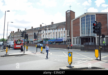 Young woman crossing the street - Shops and traffic in East Acton in the London Borough of Hammersmith and Fulham Stock Photo