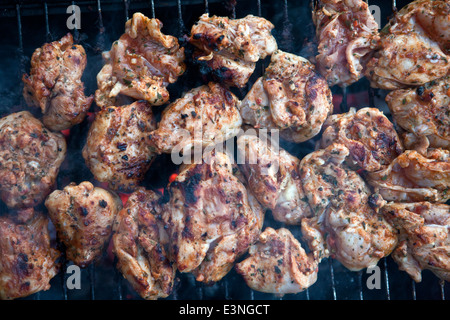 Grilling chicken in closeup Stock Photo