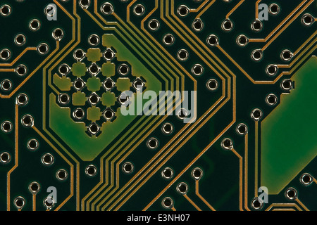 Macro-photo of small section of PC motherboard showing surface architecture of the connecting surface wires. Wiring inside computer, connected points. Stock Photo