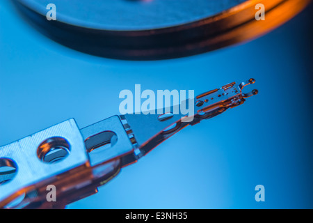 Macro-photo of HDD read-write head and armature over drive platter. For focus point see 'Description' section. Abstract data. Stock Photo