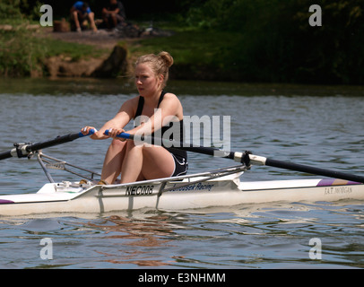 Young woman rowing a single scull on the River Thames at Oxford, UK Stock Photo