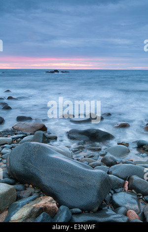 Sunset rocky sea shore Guernsey Stock Photo