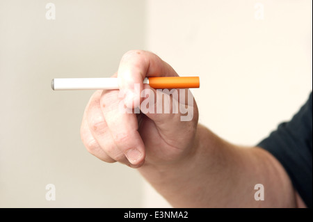 Man holding an electronic disposable E Cigarette (e-cigarette) Stock Photo
