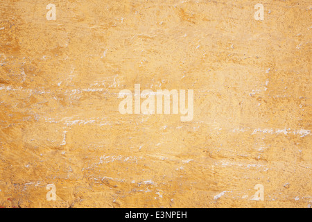 abstract pattern of part of old ochre painted brick wall Stock Photo