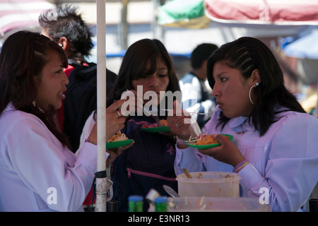 Bolivian women eating traditional empanadas. Potosi. Bolivia Stock Photo
