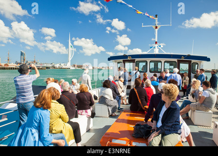 Tourists on a harbour boat trip around Portsmouth Harbour. Stock Photo