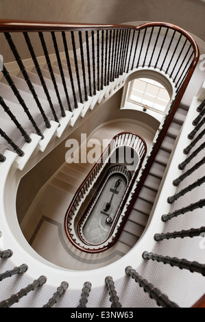 View looking down six flights of an eliptical staircase Stock Photo