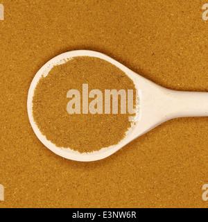 A wooden spoon on curry forming a background Stock Photo