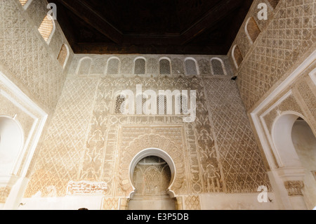 Original cedarwood roof above intricately patterned ceramic tiles and plasterwork on walls of the Museum of Marrakech, Morocco Stock Photo