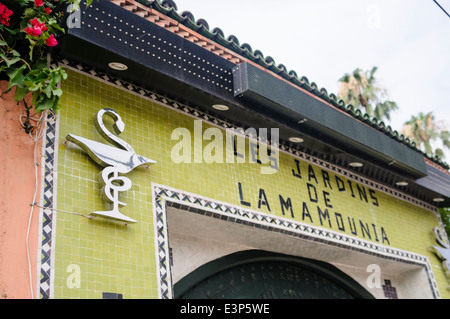 Sign saying 'Les Jardins de la Mamounia' above the entrance to a pharmacy in Marrakech, Morocco Stock Photo