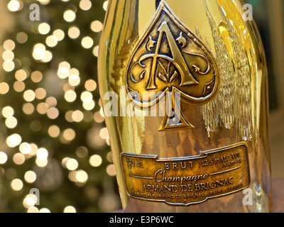 CHAMPAGNE Armand de Brignac ' Ace of Spades'' fine luxury champagne bottle with distinctive luxury metallic gold casing with sparkling lights behind Stock Photo