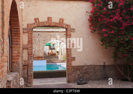Woman reads near the pool at Hacienda Sepulveda in Lagos de Moreno, Jalisco, Mexico. Stock Photo