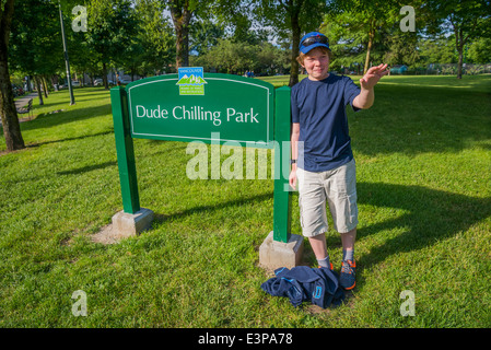 Pre teen by Dude Chilling Park sign, Vancouver, British Columbia, Canada Stock Photo