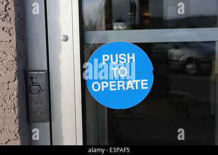 Push to operate door sign. Stock Photo