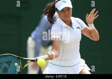 London, London, UK. 26th June, 2014. China's Zheng Jie returns the ball during the women's singles second round match against Serbia's Ana Ivanovic at the 2014 Wimbledon Championships in Wimbledon, southwest London, June 26, 2014. Credit:  Meng Yongmin/Xinhua/Alamy Live News Stock Photo