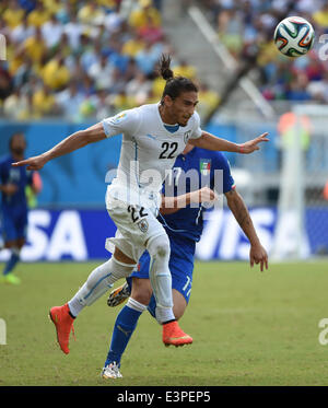 Natal, Brazil. 24th June, 2014. Uruguay's Martin Caceres vies for the ball with Italy's Ciro Immobile during a Group D match between Italy and Uruguay of 2014 FIFA World Cup at the Estadio das Dunas Stadium in Natal, Brazil, June 24, 2014. © Guo Yong/Xinhua/Alamy Live News Stock Photo