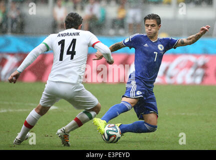 Salvador, Brazil. 24th June, 2014. Bosnia And Herzegovina's Muhamed Besic vies with Iran's Andranik Timotian during a Group F match between Bosnia And Herzegovina and Iran of 2014 FIFA World Cup at the Arena Fonte Nova Stadium in Salvador, Brazil, June 24, 2014.Bosnia And Herzegovina won 3-1 over Iran on Wednesday. © Cao Can/Xinhua/Alamy Live News Stock Photo