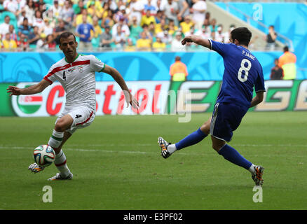 Salvador, Brazil. 24th June, 2014. Bosnia And Herzegovina's Enzo Perez vies with Iran's Jalal Hosseini during a Group F match between Bosnia And Herzegovina and Iran of 2014 FIFA World Cup at the Arena Fonte Nova Stadium in Salvador, Brazil, June 24, 2014.Bosnia And Herzegovina won 3-1 over Iran on Wednesday. © Cao Can/Xinhua/Alamy Live News Stock Photo