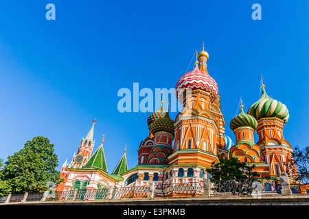 St. Basil's Cathedral on Red Square and Spasskaya (Savior's) tower of Moscow Kremlin in sunny morning of June, 2014 Stock Photo