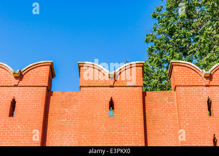 Closeup view and top part of Moscow Kremlin wall of red bricks against clear blue sky Stock Photo