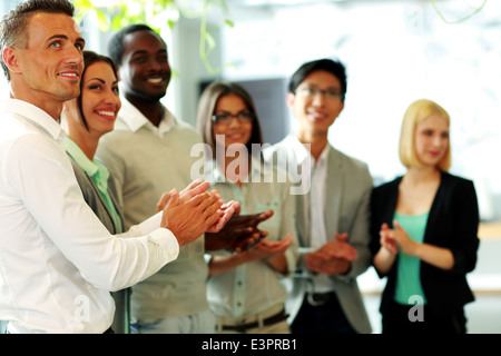 Group of a happy business team applauding Stock Photo