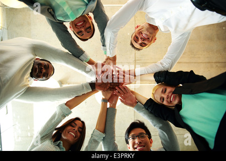 business people teamwork in an office with hands together Stock Photo