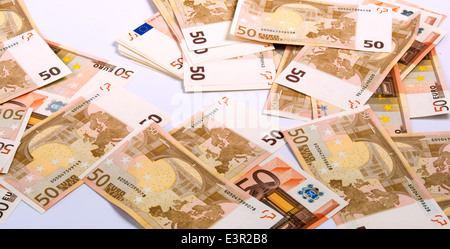 The background consists of many euro banknotes of different ...