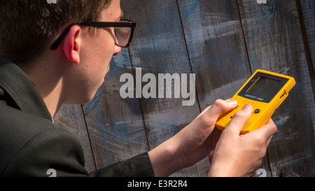 School Teenager Playing on a Nintendo Game Boy Color. Stock Photo