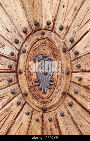Detailed view of a wooden door with emblem Stock Photo